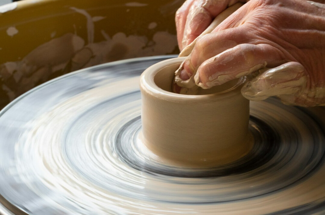 Elderly Japanese woman learning pottery at a craft workshop
