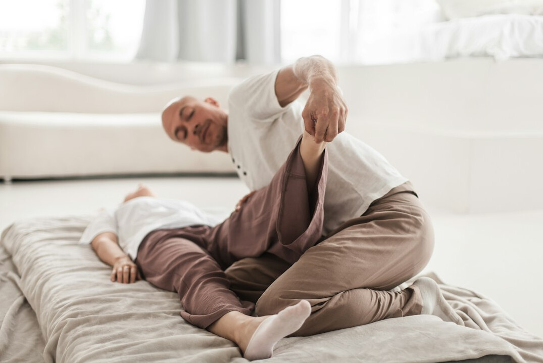 Japanese senior citizens doing light stretching exercise in a sunny room