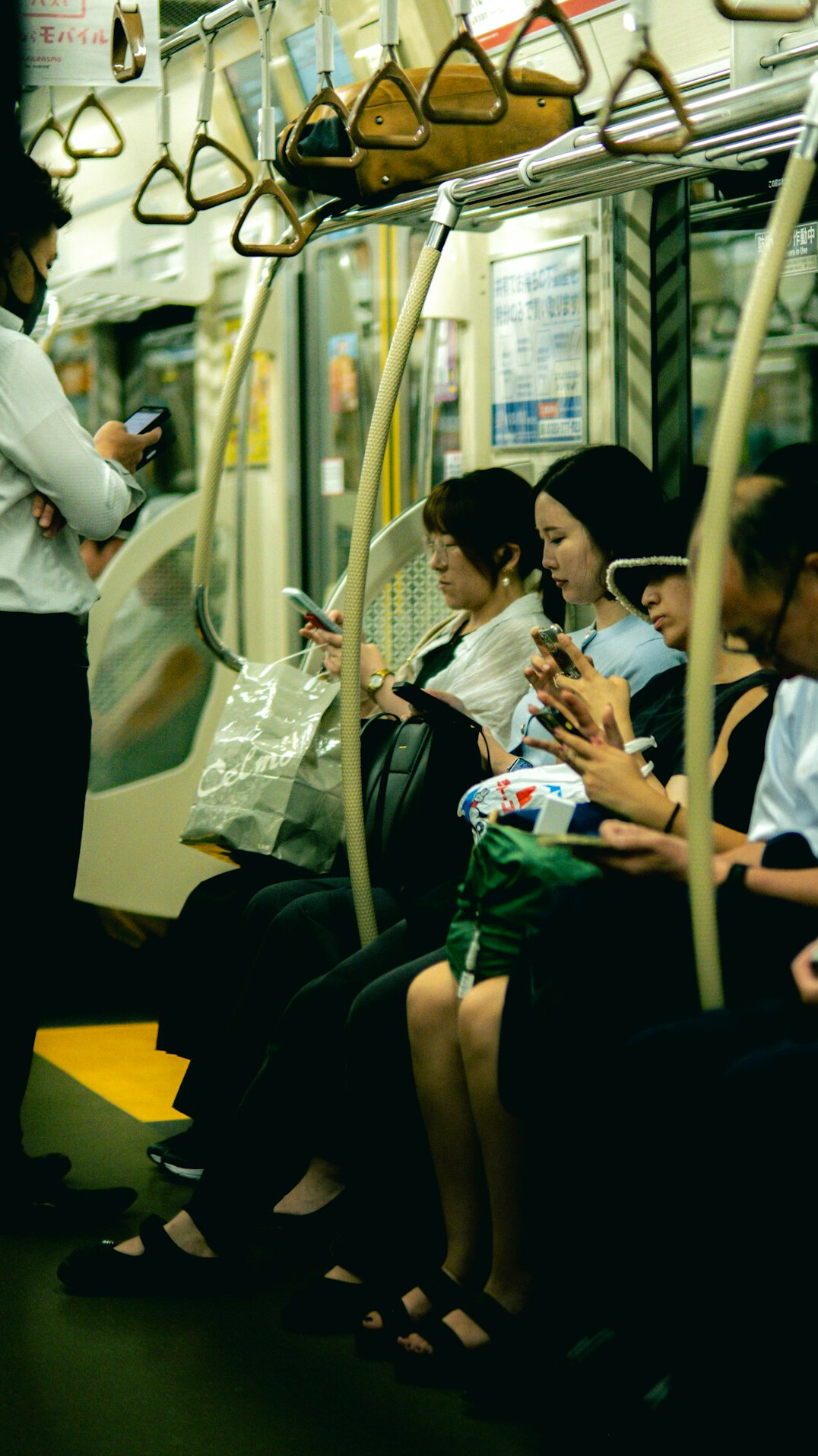 Elderly Japanese students attending a smartphone class taught by a young instructor